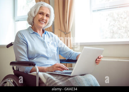 Disabled woman using computer Stock Photo