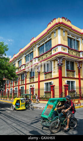 street with trike cyclo taxis in colonial architecture intramuros tourist area of old manila city philippines Stock Photo