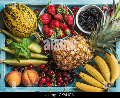 Healthy summer fruit variety. Sweet cherries, strawberries, blackberries, peaches, bananas, melon slices and mint leaves Stock Photo