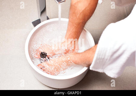 man making a kneipp footbath Stock Photo