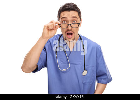 Surprised male doctor posing in a blue uniform isolated on white background Stock Photo
