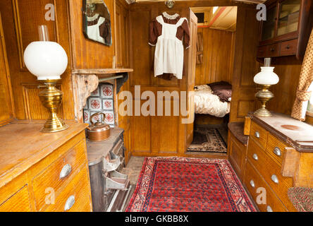 The interior of a vintage living wagon used by a traveling ploughman or road man pulled behind a steam roller Stock Photo