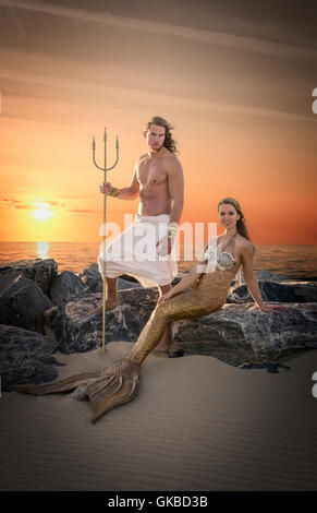 King Neptune and a mermaid on rocks by the beach, Virginia Beach, VA Stock Photo