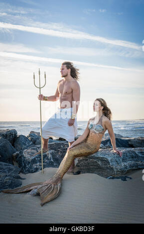 King Neptune and a mermaid on rocks by the beach, Virginia Beach, VA Stock Photo