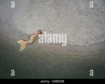 Mermaid laying on a sandbar in Virginia Beach, VA Stock Photo