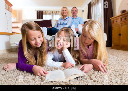 family reading a book together Stock Photo