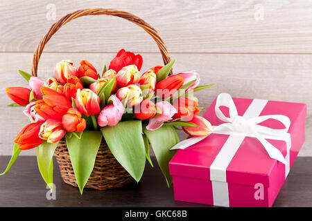 gift in pink with tulips and easter eggs Stock Photo