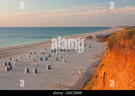 beach with beach chairs on the red cliff in kampen on sylt in the evening light Stock Photo