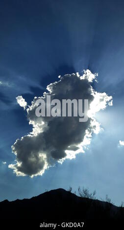 Dramatic sunrays radiating behind a cloud above the Anza-Borrego Sonoran Desert Stock Photo