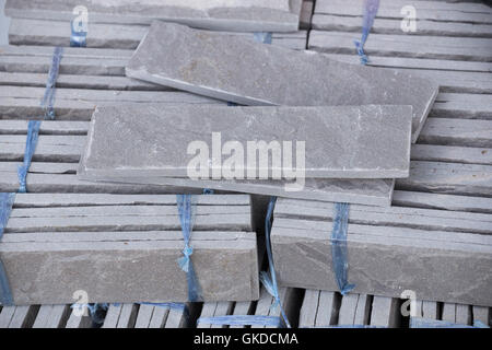 pile of gray stone tiles prepare for install with cement for house decoration Stock Photo