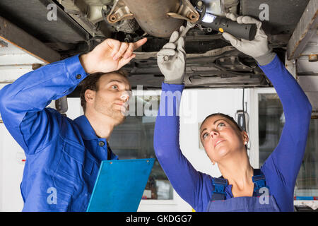 two mechanics repairing a car Stock Photo