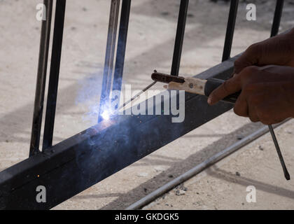 worker welding at manufacturing , welding door frames Stock Photo