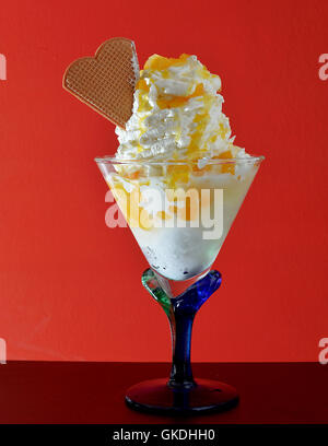 a big glass of delicious ice cream with plenty of topping Stock Photo