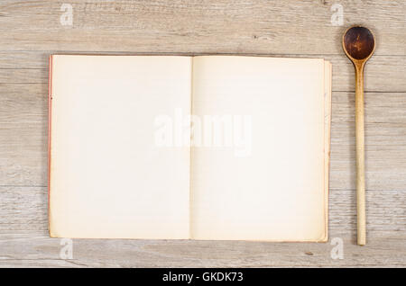 old paper in a book with wooden spoon Stock Photo