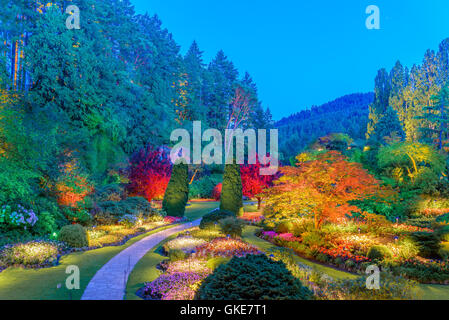 The Sunken Garden illuminated at night, Butchart Gardens, Brentwood Bay, Greater Victoria, British Columbia, Canada Stock Photo