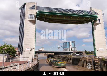 The tidal surge barrier with tank barge Swinderby  passing beneath, Kingston upon Hull, Yorkshire, England, UK Stock Photo