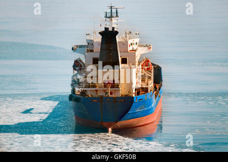 Cargo ship on the ice sea in winter Stock Photo