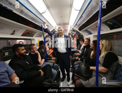 Mayor of London Sadiq Khan travelling with passengers on a northbound Victoria line tube train during the launch of London's Night Tube, as trains will operate overnight on Fridays and Saturdays on the Victoria line and parts of the Central line, with the Jubilee, Northern and Piccadilly lines following in the autumn. Stock Photo
