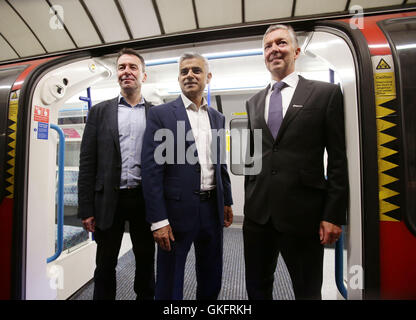 Mayor of London Sadiq Khan (centre) with Mark Wild (left), Managing Director of London Underground, and Mike Brown, commissioner of transport for London, on a Victoria tube train carriage at Brixton Underground station during the launch of London's Night Tube, as trains will operate overnight on Fridays and Saturdays on the Victoria line and parts of the Central line, with the Jubilee, Northern and Piccadilly lines following in the autumn. Stock Photo