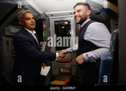 Mayor of London Sadiq Khan (left) with Daniel George - driver of the first Night Tube - in the drivers carriage of a Victoria line tube train at Brixton Underground station during the launch of London's Night Tube, as trains will operate overnight on Fridays and Saturdays on the Victoria line and parts of the Central line, with the Jubilee, Northern and Piccadilly lines following in the autumn. Stock Photo