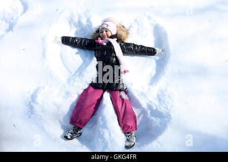 Beautiful little girl in winter park Stock Photo