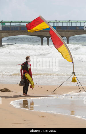 Bournemouth, UK. 20 August 2016. RNLI Lifeguard keeps a good lookout on patrol near Boscombe pier in rough conditions with strong winds and high tides Credit:  Carolyn Jenkins/Alamy Live News Stock Photo