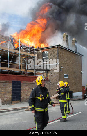 Ilford, London, UK. 20th August, 2016. six fire engines and a height platform, and around 30 firefighters tackled a blaze in a hotel undergoing renovation on Cranbrook Road in Ilford, The fire has resulted in nearby roads being closed to traffic. The fire appears to have destroyed much of the roof. There are thought to be no injuries as a result of late afternoon blaze. An investigation into the cause of the fire will be carried out by London Fire brigade Credit:  HOT SHOTS/Alamy Live News Stock Photo