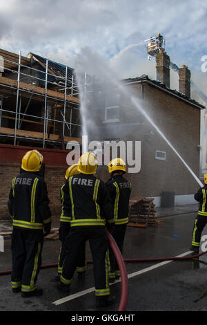 Ilford, London, UK. 20th August, 2016. six fire engines and a height platform, and around 30 firefighters tackled a blaze in a hotel undergoing renovation on Cranbrook Road in Ilford, The fire has resulted in nearby roads being closed to traffic. The fire appears to have destroyed much of the roof. There are thought to be no injuries as a result of late afternoon blaze. An investigation into the cause of the fire will be carried out by London Fire brigade Credit:  HOT SHOTS/Alamy Live News Stock Photo