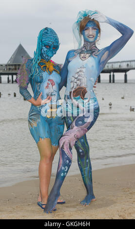 Usedom island, Heringsdor, USA. 20th Aug, 2016. Nancy and Svena model the work of body painting artists during the body painting festival in Heringsdor on Usedom island, Germany, 20 August 2016. Body painter from Germany, the Netherlands, Switzerland and Australia present their art during the festival. Photo: Stefan Sauer/dpa © dpa picture alliance/Alamy Live News Credit:  dpa picture alliance/Alamy Live News Stock Photo