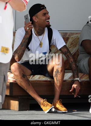 Chris Brown plays with his mobile phone ahead of his performance at the Fresh Island Festival 2016 in Novalja, Croatia. Chris, who is all smiles, is also spotted smoking a hand-rolled cigarette.  Featuring: Chris Brown Where: Novalja, Croatia When: 14 Jul Stock Photo