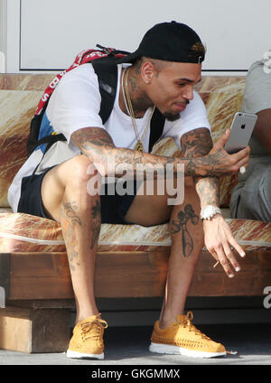 Chris Brown plays with his mobile phone ahead of his performance at the Fresh Island Festival 2016 in Novalja, Croatia. Chris, who is all smiles, is also spotted smoking a hand-rolled cigarette.  Featuring: Chris Brown Where: Novalja, Croatia When: 14 Jul Stock Photo