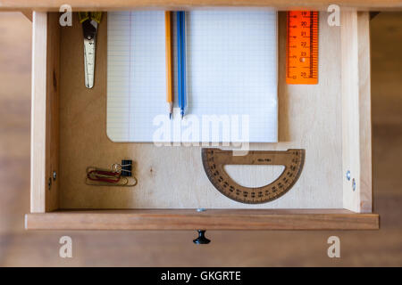 above view of stationery set in open drawer of nightstand Stock Photo