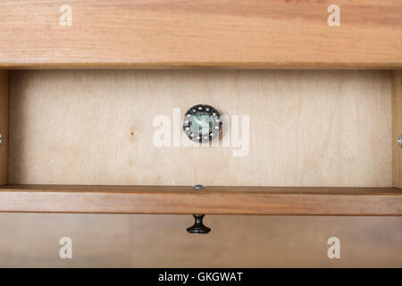 top view of vintage little silver casket with gem on cover in open drawer of nightstand Stock Photo