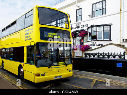 Whitby town tour bus passing the Magpie Café, Whitby, North Yorkshire, England UK Stock Photo