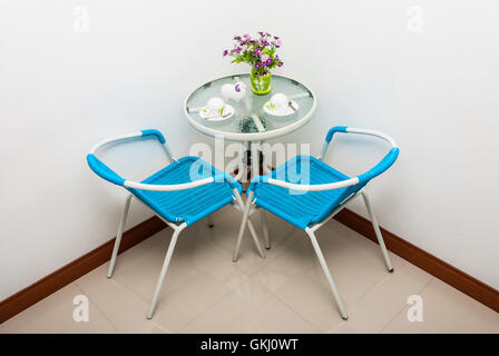 Metal Glass Coffee Table Set in Corner Stock Photo