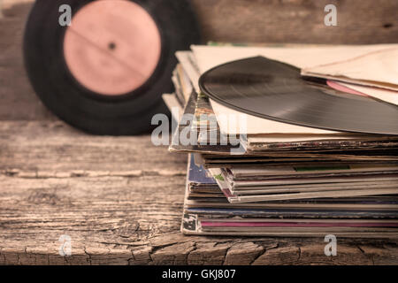 stack of old records on the old wooden background in vintage style (sepia) Stock Photo