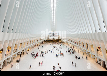 Shoppers and tourists enjoy the view inside the Oculus and stores in the Westfield World Trade Center mall in New York City. Stock Photo