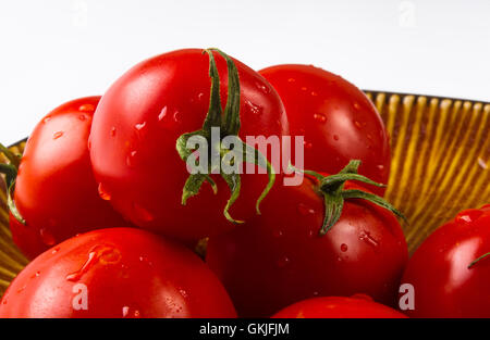 still life - ripe small tomatoes on brown plate Stock Photo