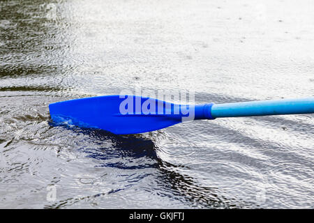 paddle blade in water during boating on the pond in rain Stock Photo