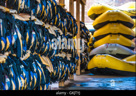 Life vests and rubber rafts ready for whitewater rafting action in Columbus, Georgia on the Chattahoochee River. (USA) Stock Photo