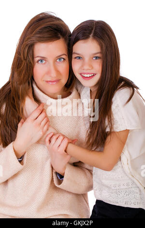Close up portrait of a beautiful ten year old little girl and happy mother, isolated on white background Stock Photo