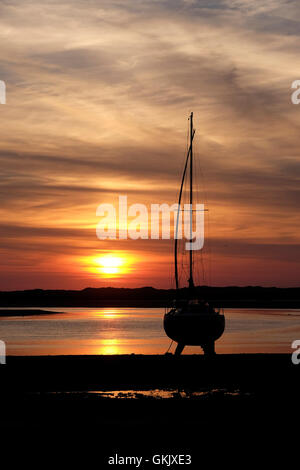 vertical photo of yacht in silhouette at sunset Stock Photo