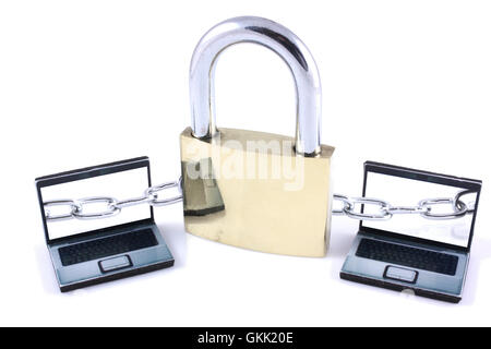 Two laptops chained to a large padlock on a white background Stock Photo