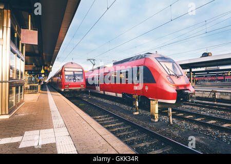 Beautiful railway station with modern high speed red train Stock Photo