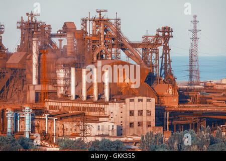 Industrial buildings . Steel factory at sunset. Pipes with smoke. Metallurgical plant. steelworks, iron works. Heavy industry in