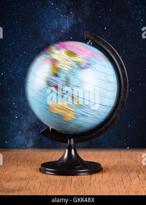 spinning globe on the background of night sky Stock Photo