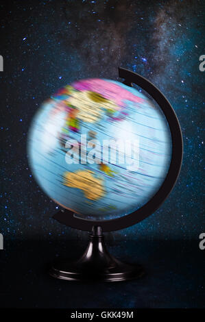 spinning globe on the background of night sky Stock Photo