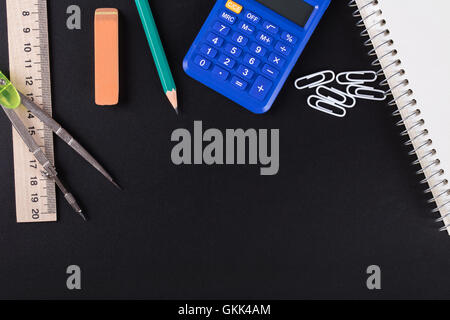 calculator and Office supplies on a black background Stock Photo
