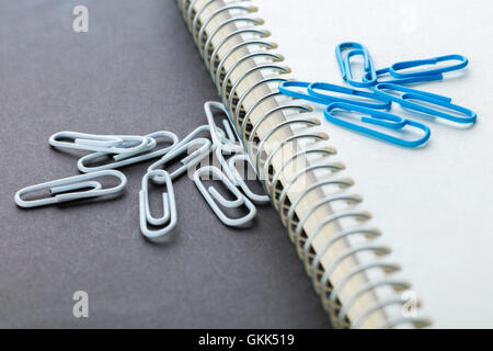 notebook and paper clips close-up on a black background Stock Photo