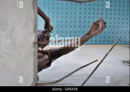 A builder pauses during work on a building being constructed on one of the crash sites of Black Hawk Down in the Somali capital of Mogadishu on October 2. Two decades after the infamous Battle of Mogadishu, in which the United States lost eighteen soldiers during a mission into Bakara Market, Somalia is finally showing signs of recovery from its more than two decades of civil war. Nowhere is this more evident than in Mogadishu's Bakara Market, where business is thriving and new shops continue to be opened everyday. AU UN IST PHOTO / TOBIN JONES. Stock Photo